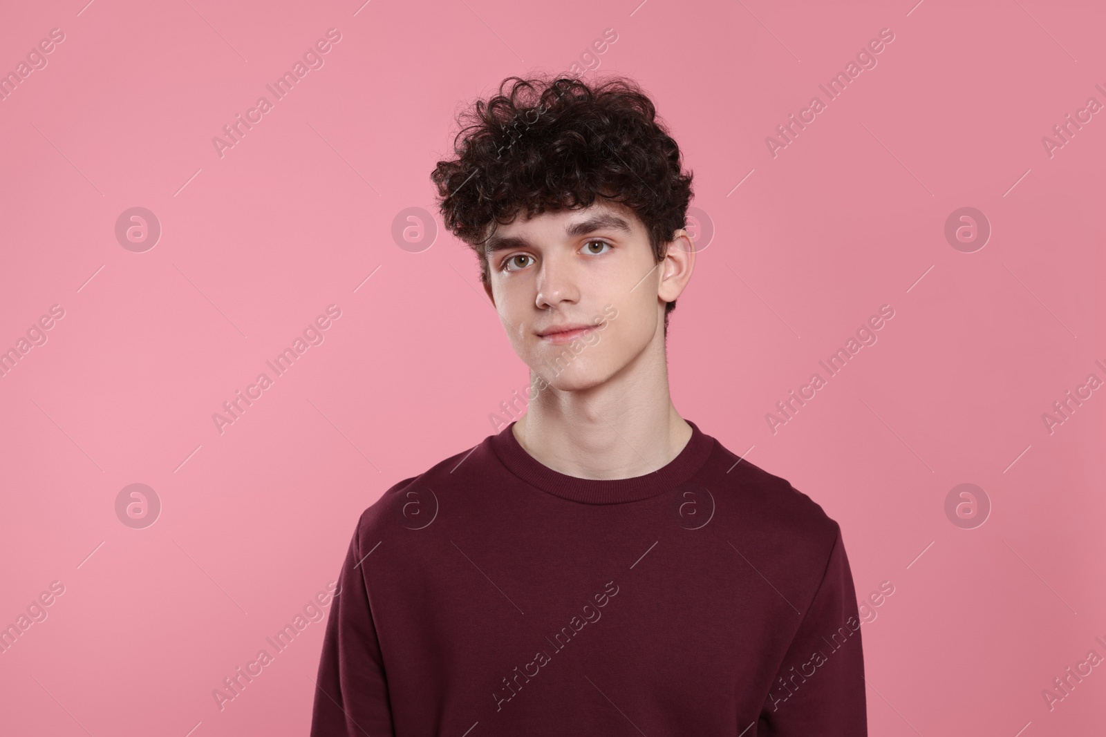 Photo of Portrait of cute teenage boy on pink background