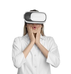 Young woman using virtual reality headset on white background