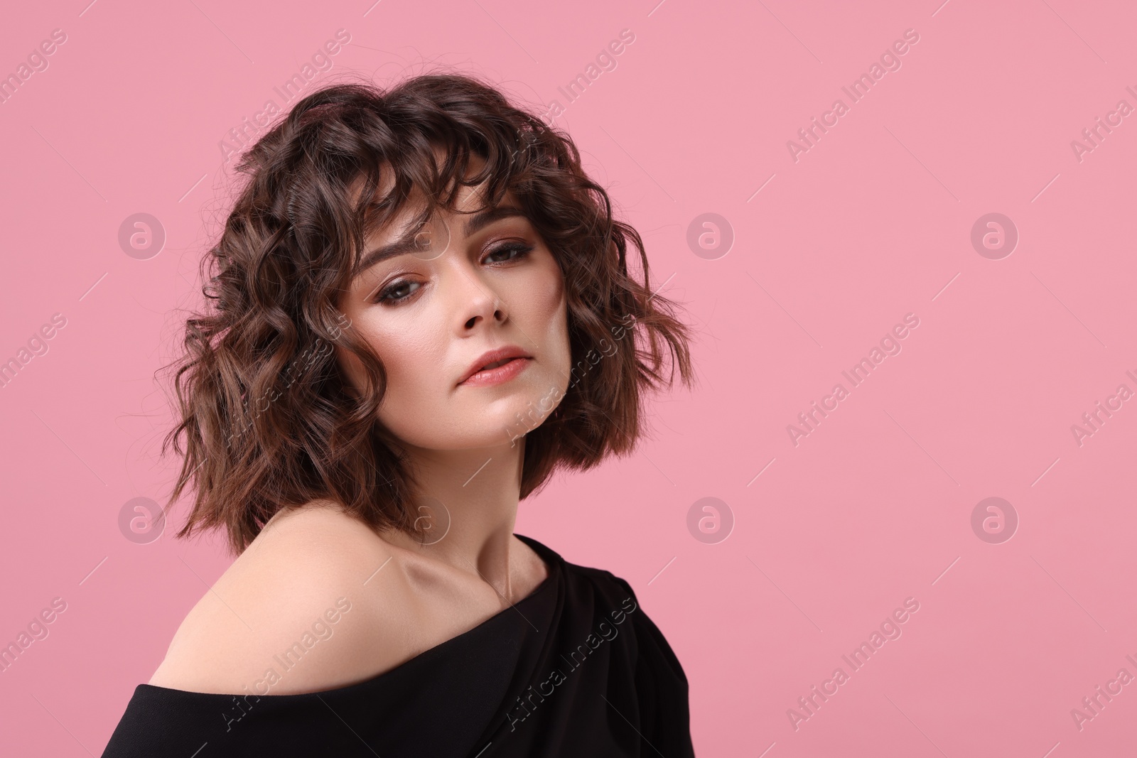 Photo of Portrait of beautiful young woman with wavy hairstyle on pink background. Space for text