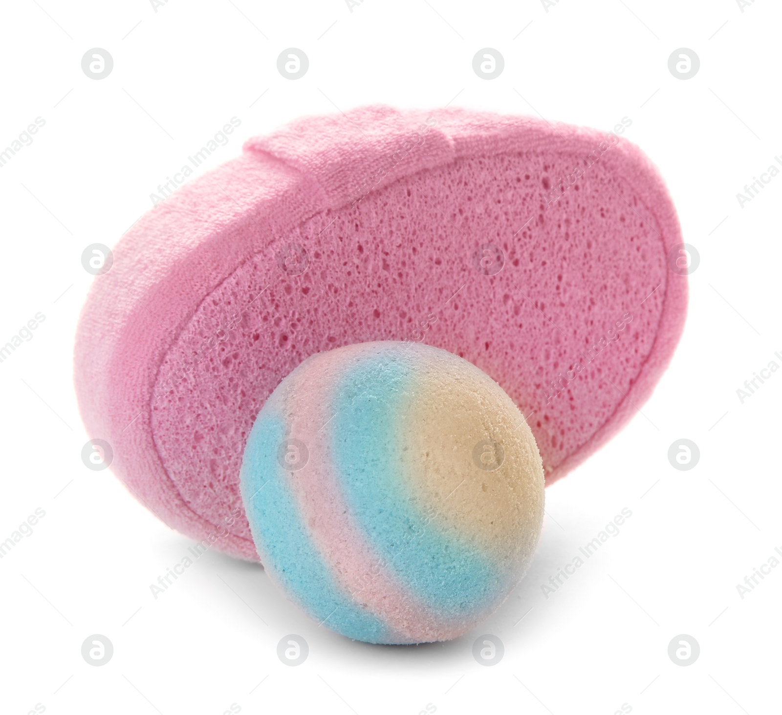 Photo of Pink sponge and bath bomb on white background