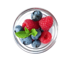 Bowl with raspberries and blueberries on white background