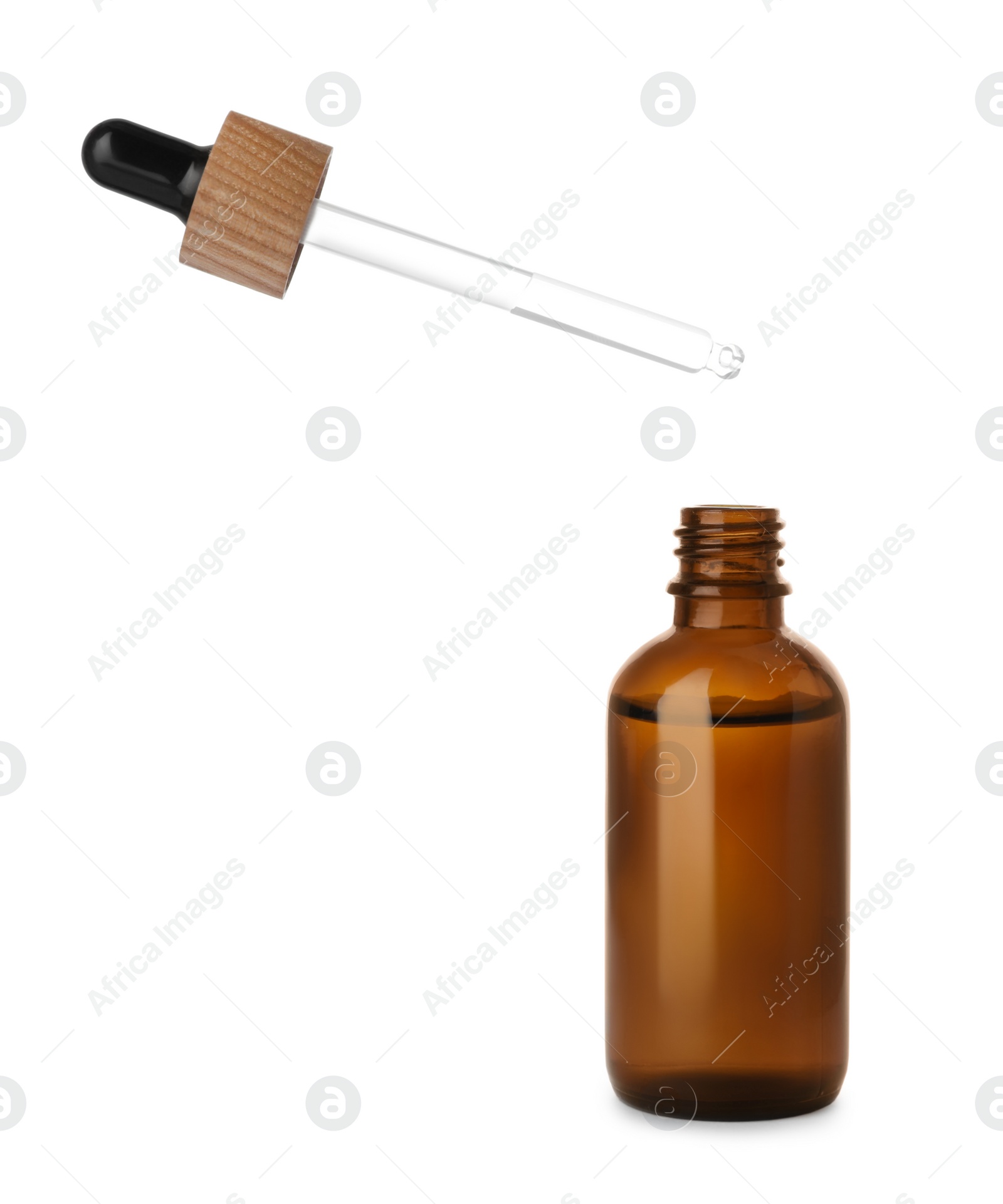 Photo of Dripping essential oil into glass bottle on white background