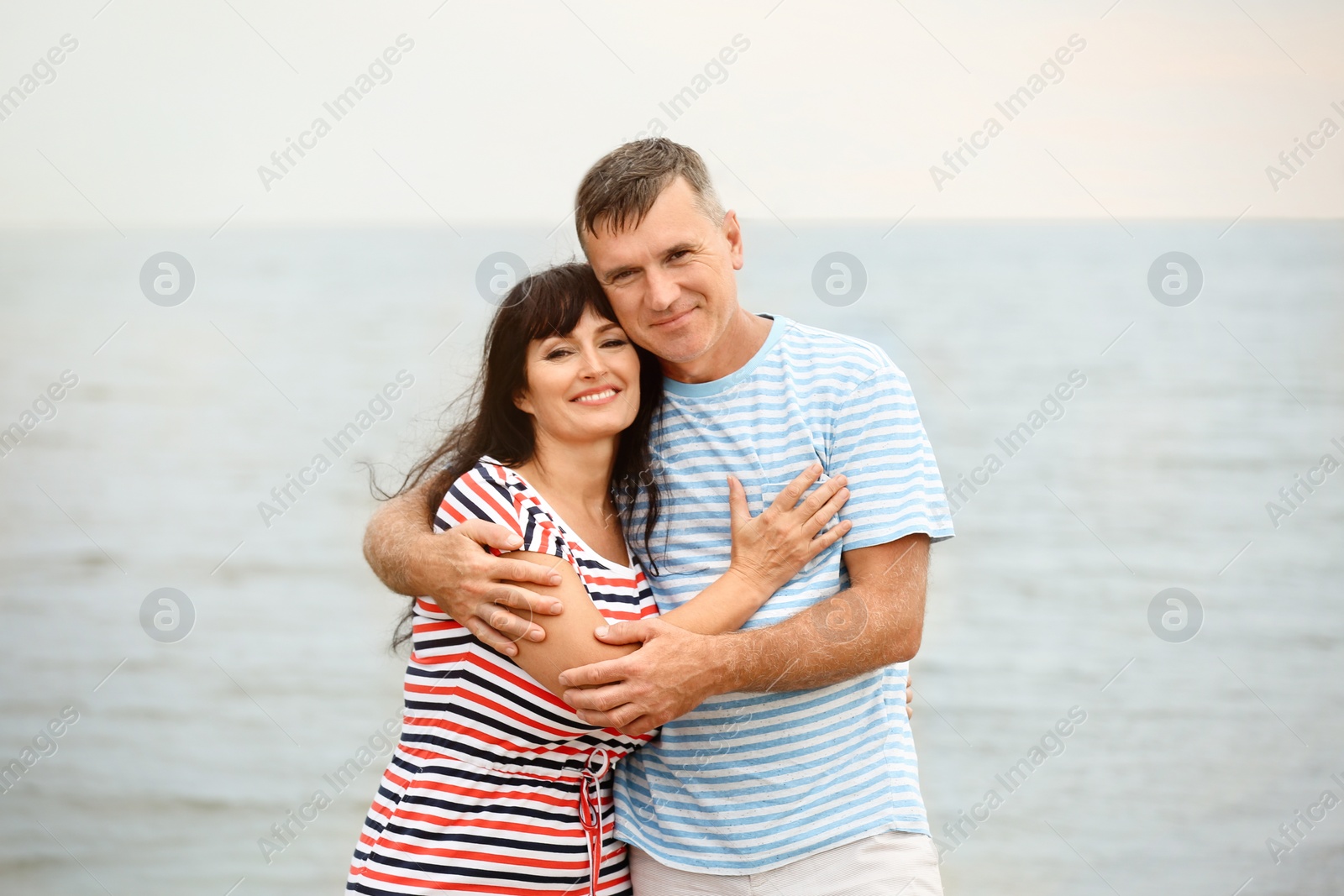 Photo of Happy mature couple spending time together on sea beach