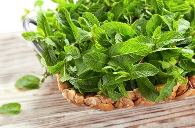 Tray with fresh mint on wooden table