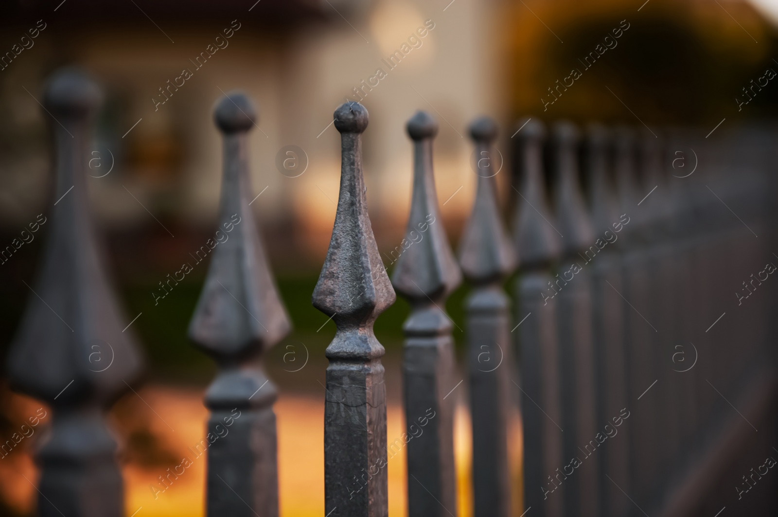 Photo of Beautiful iron fence on sunny day outdoors, closeup