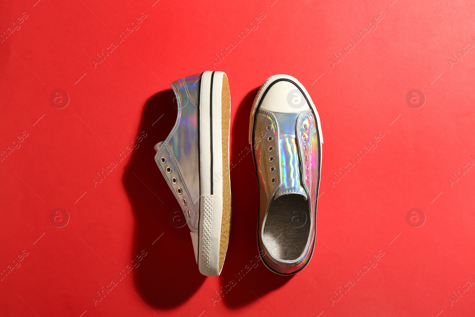 Photo of Pair of stylish sneakers on color background, flat lay