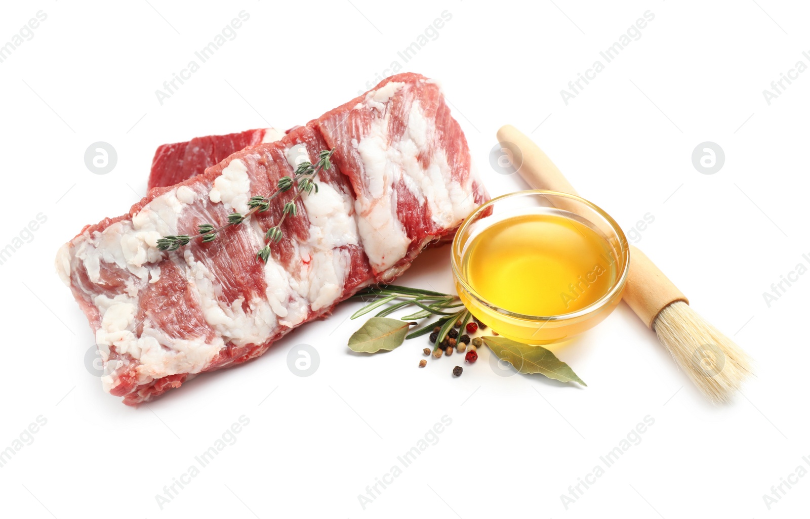 Photo of Raw ribs with herbs and oil on white background