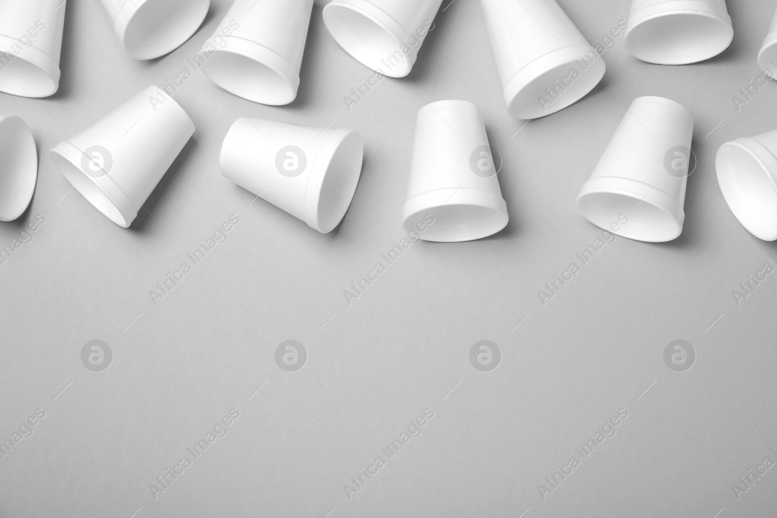 Photo of Many styrofoam cups on light grey background, flat lay. Space for text