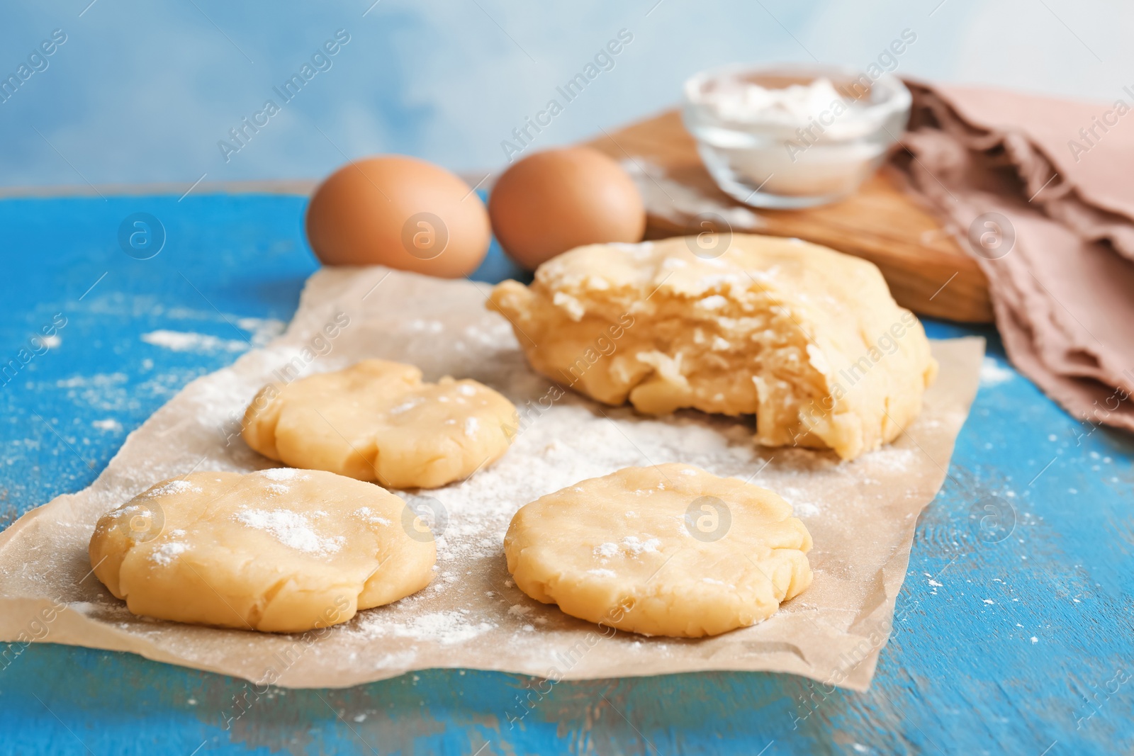 Photo of Pieces of fresh raw dough on wooden table