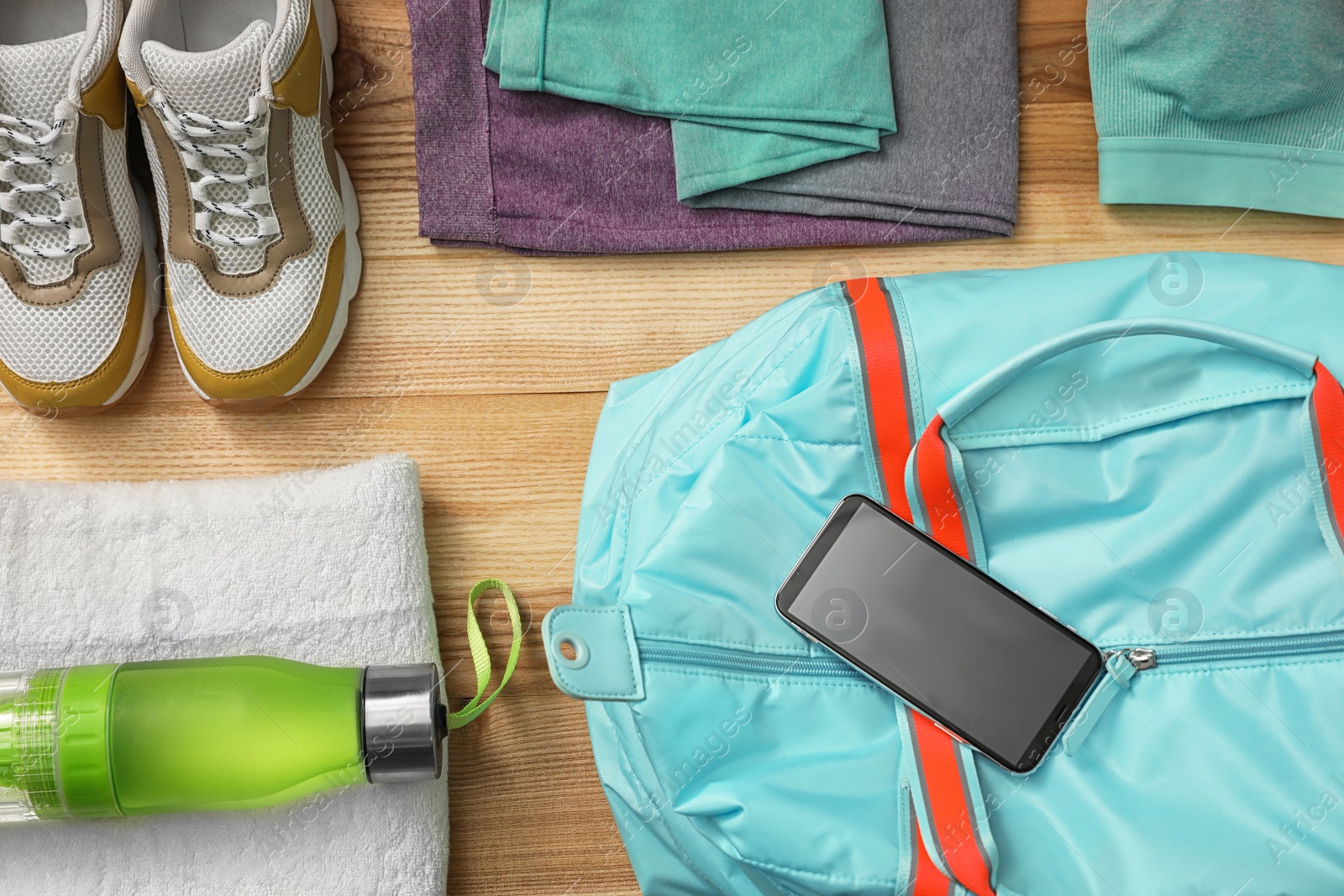 Photo of Flat lay composition with sports bag on wooden background