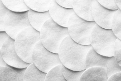 Many cotton pads as background, top view