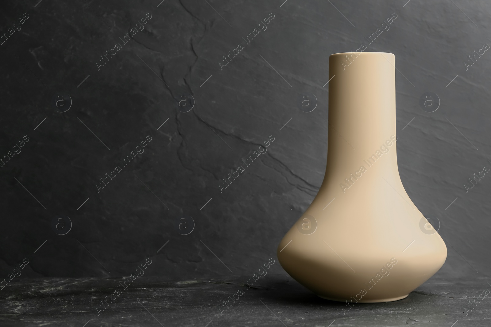 Photo of Stylish empty ceramic vase on black table, space for text