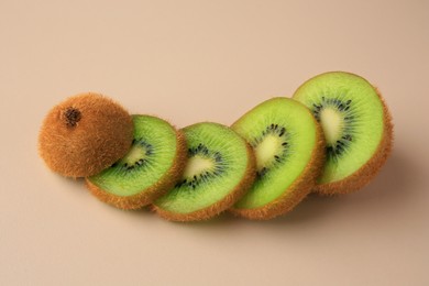 Photo of Sliced fresh ripe kiwi on beige background