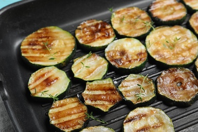 Photo of Delicious zucchini slices on grill pan, closeup