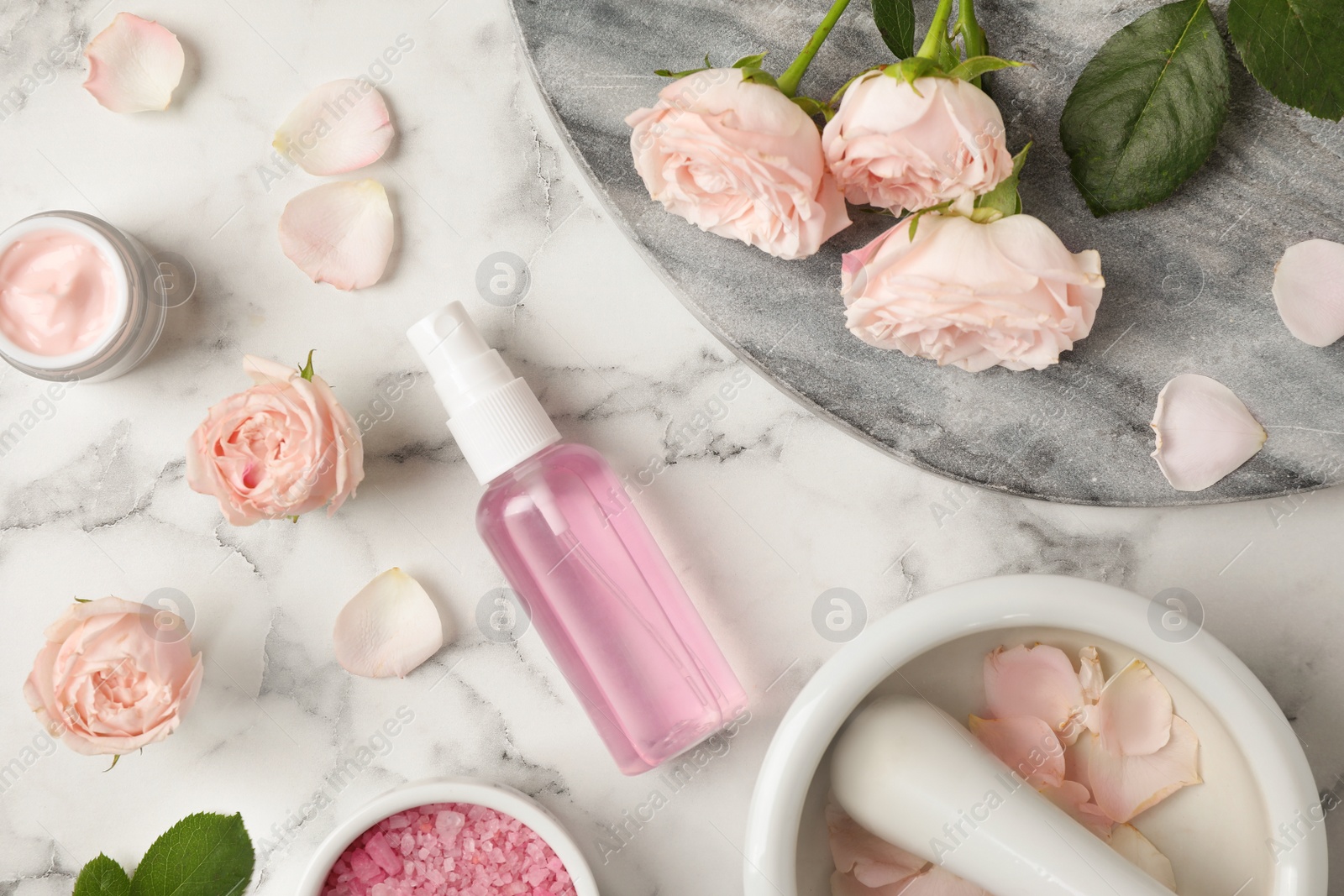 Photo of Flat lay composition with rose essential oil on marble table