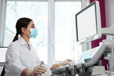 Photo of Sonographer using modern ultrasound machine in clinic