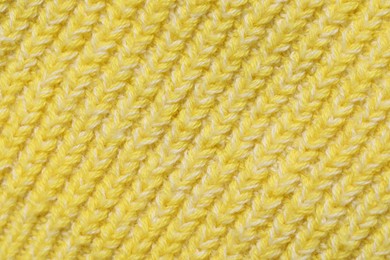 Photo of Texture of soft yellow fabric as background, top view