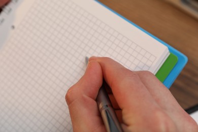 Man taking notes at table, closeup view