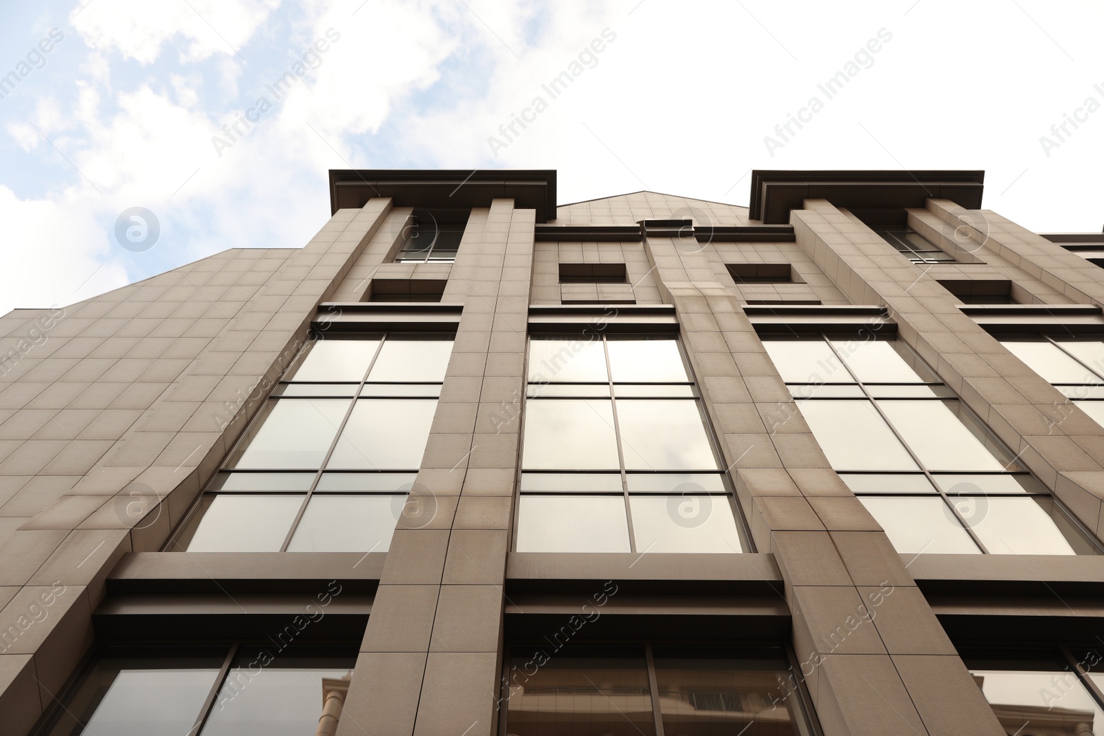 Photo of Modern office building with tinted windows on sunny day