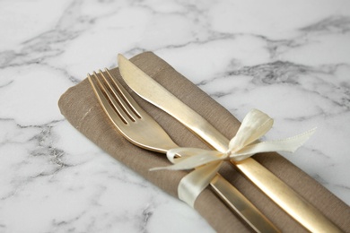 Photo of Cutlery set for festive table on white marble background