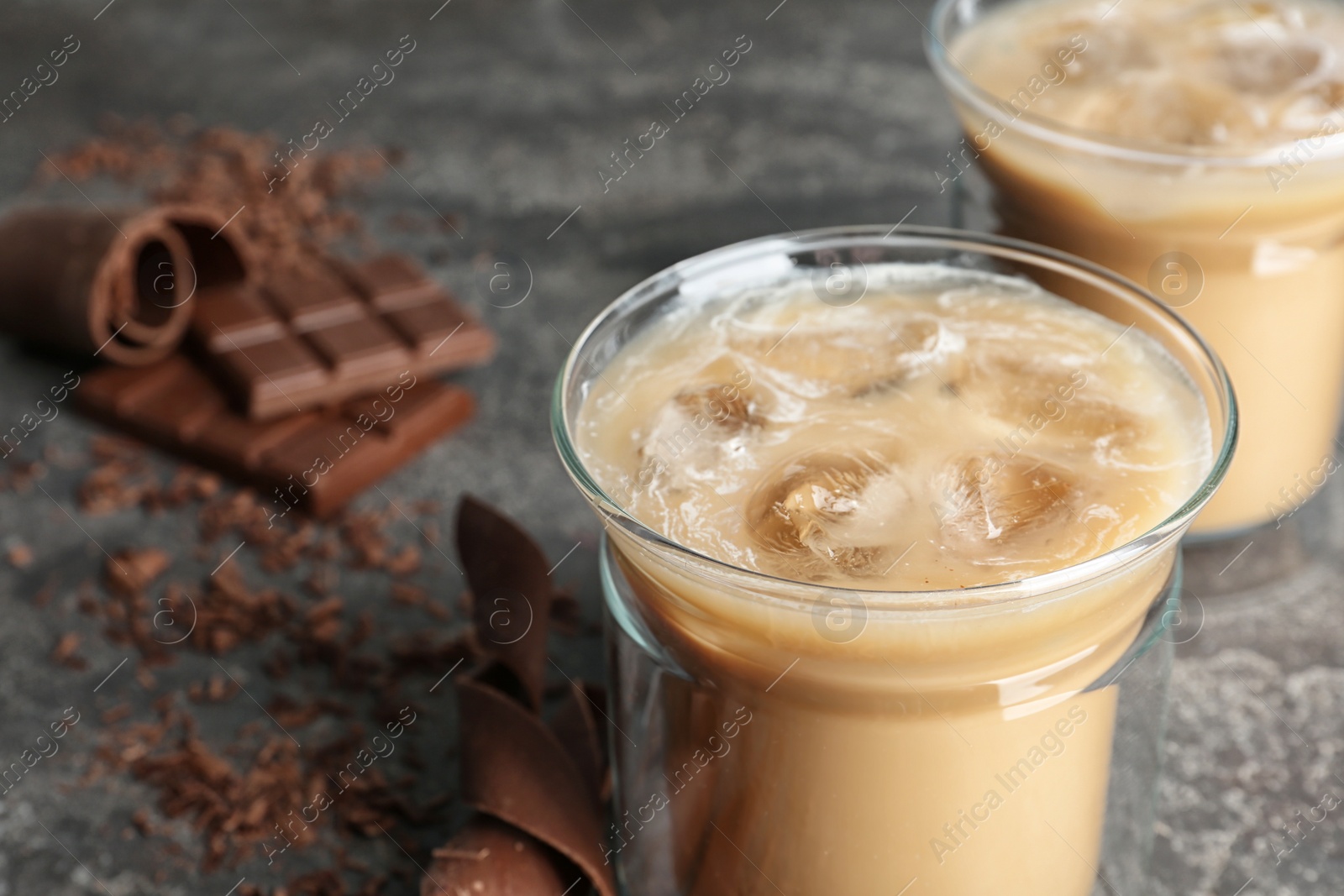 Photo of Glass cup with iced coffee on gray table