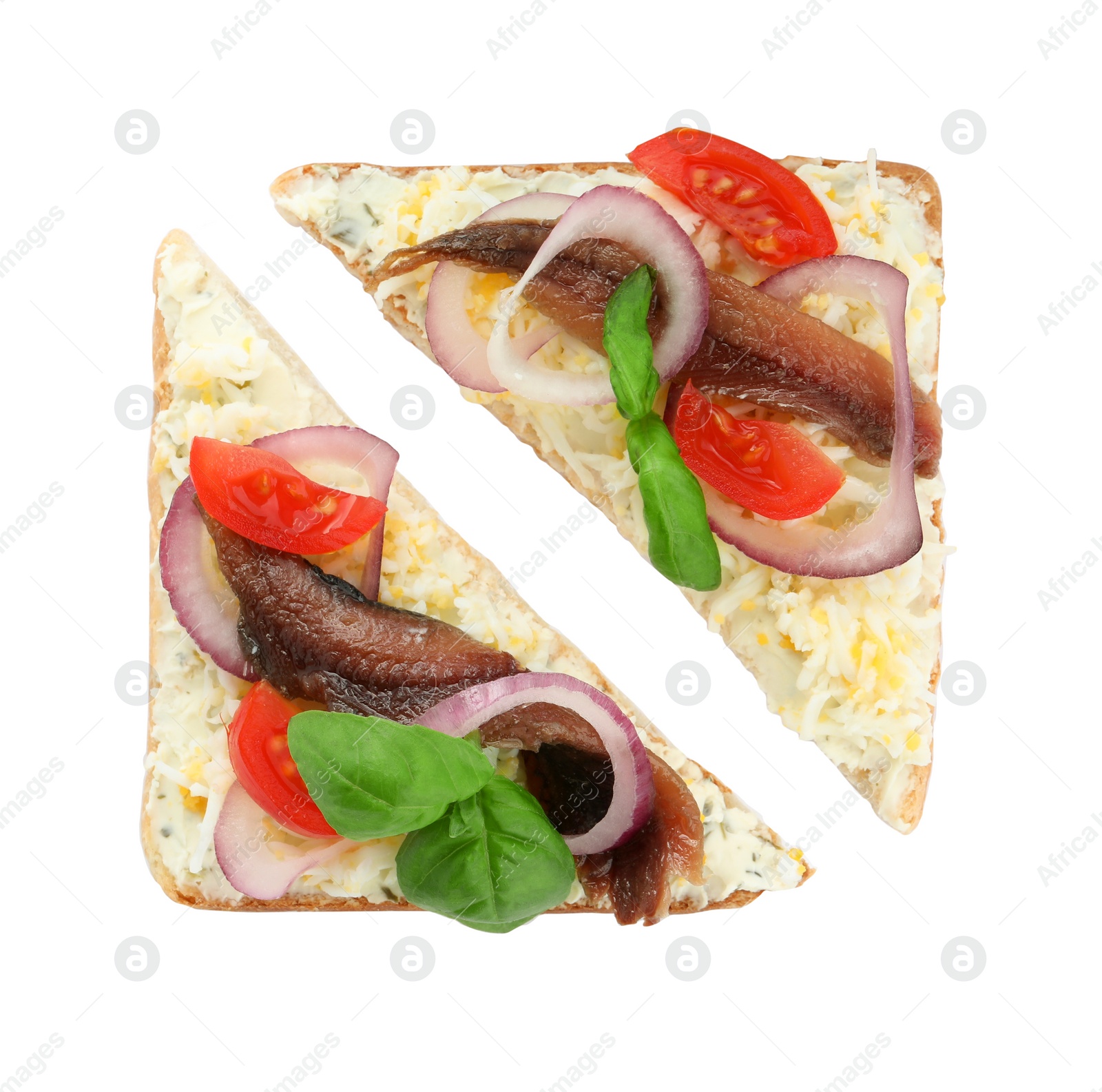 Photo of Delicious sandwiches with anchovy, tomato and basil on white background, top view