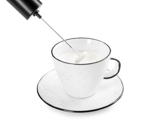 Whisking milk in cup with mini mixer (frother wand) isolated on white