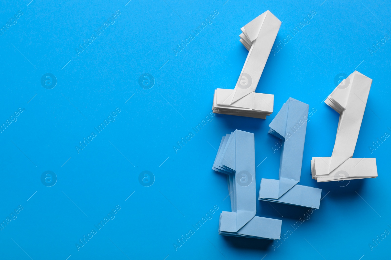 Photo of Numbers one made of paper on light blue background, flat lay. Space for text