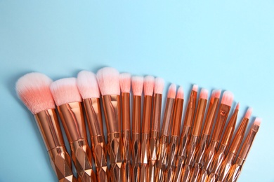 Photo of Flat lay composition with set of makeup brushes on light blue background