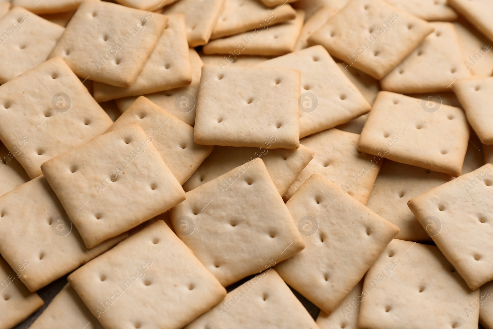 Photo of Many delicious crackers as background, closeup view