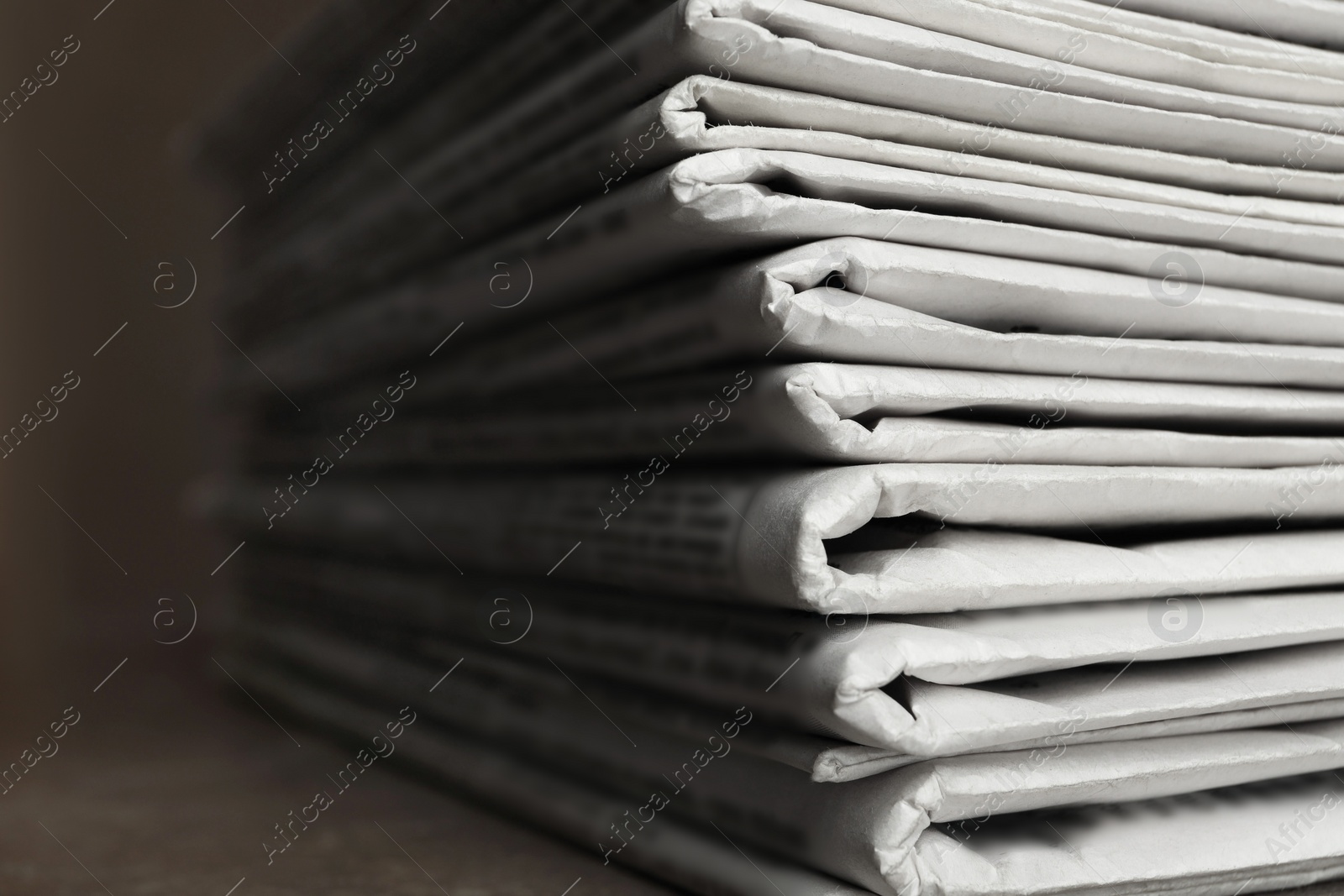 Photo of Stack of newspapers on table, closeup. Journalist's work