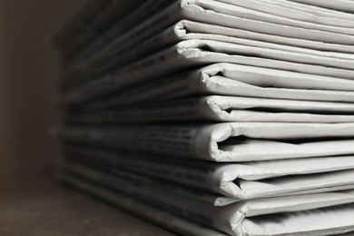 Stack of newspapers on table, closeup. Journalist's work