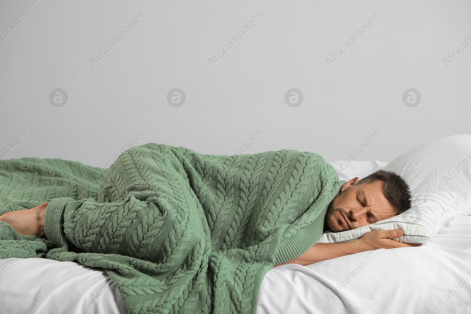 Photo of Tired man sleeping in bed at home