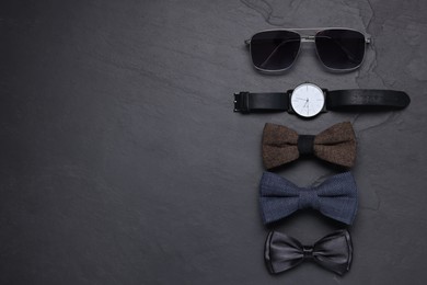 Photo of Stylish bow ties, wristwatch and sunglasses on black background, flat lay. Space for text