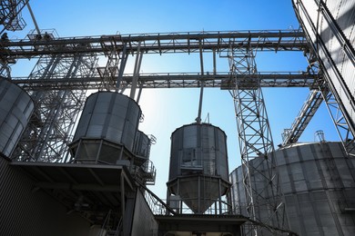 Modern granaries for storing cereal grains against blue sky, low angle view