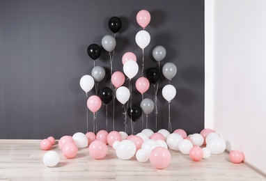 Photo of Room decorated with colorful balloons near wall