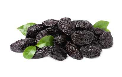 Photo of Pile of sweet dried prunes and green leaves on white background