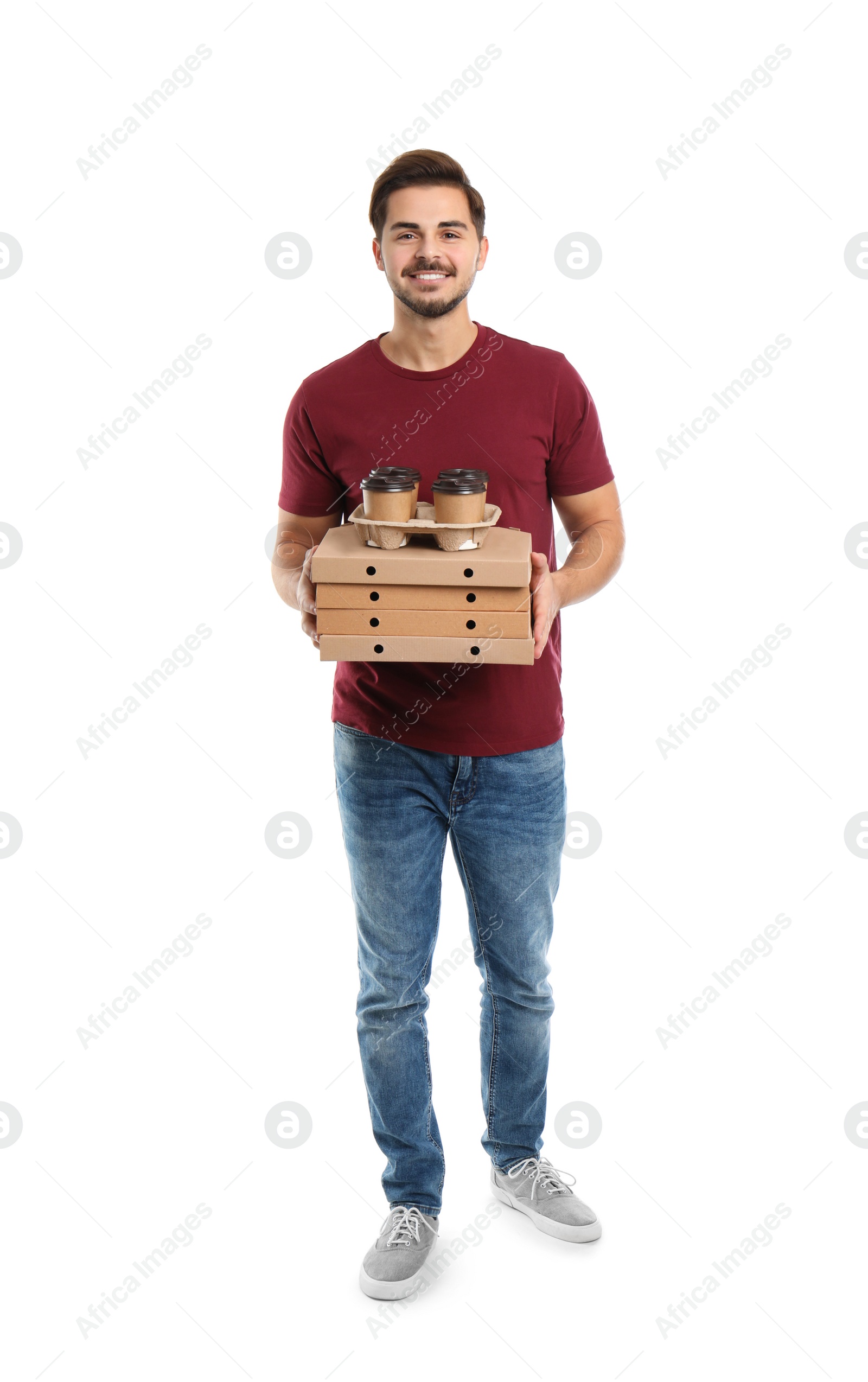 Photo of Young courier with pizza boxes and drinks on white background. Food delivery service