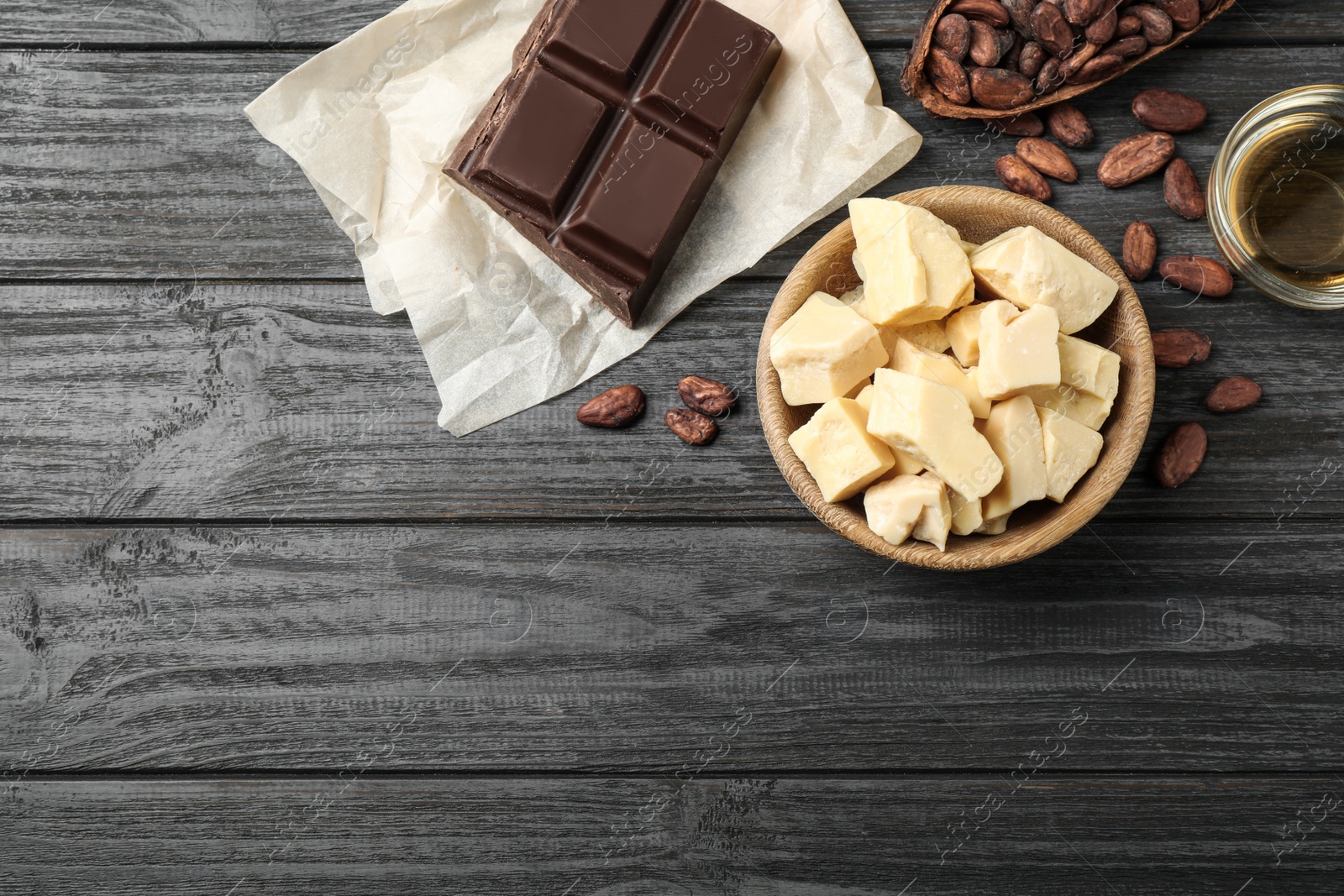 Photo of Flat lay composition with organic cocoa butter on black wooden table. Space for text