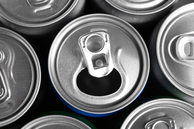 Energy drinks in cans as background, top view. Functional beverage