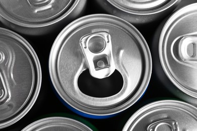 Photo of Energy drinks in cans as background, top view. Functional beverage