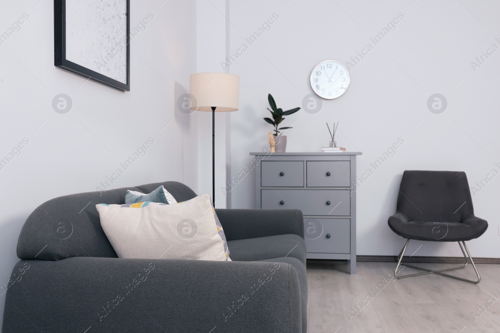 Photo of Stylish room interior with sofa and other furniture