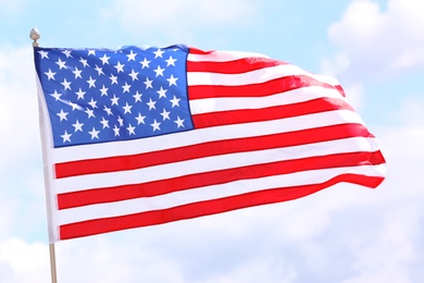 American flag fluttering outdoors on cloudy day