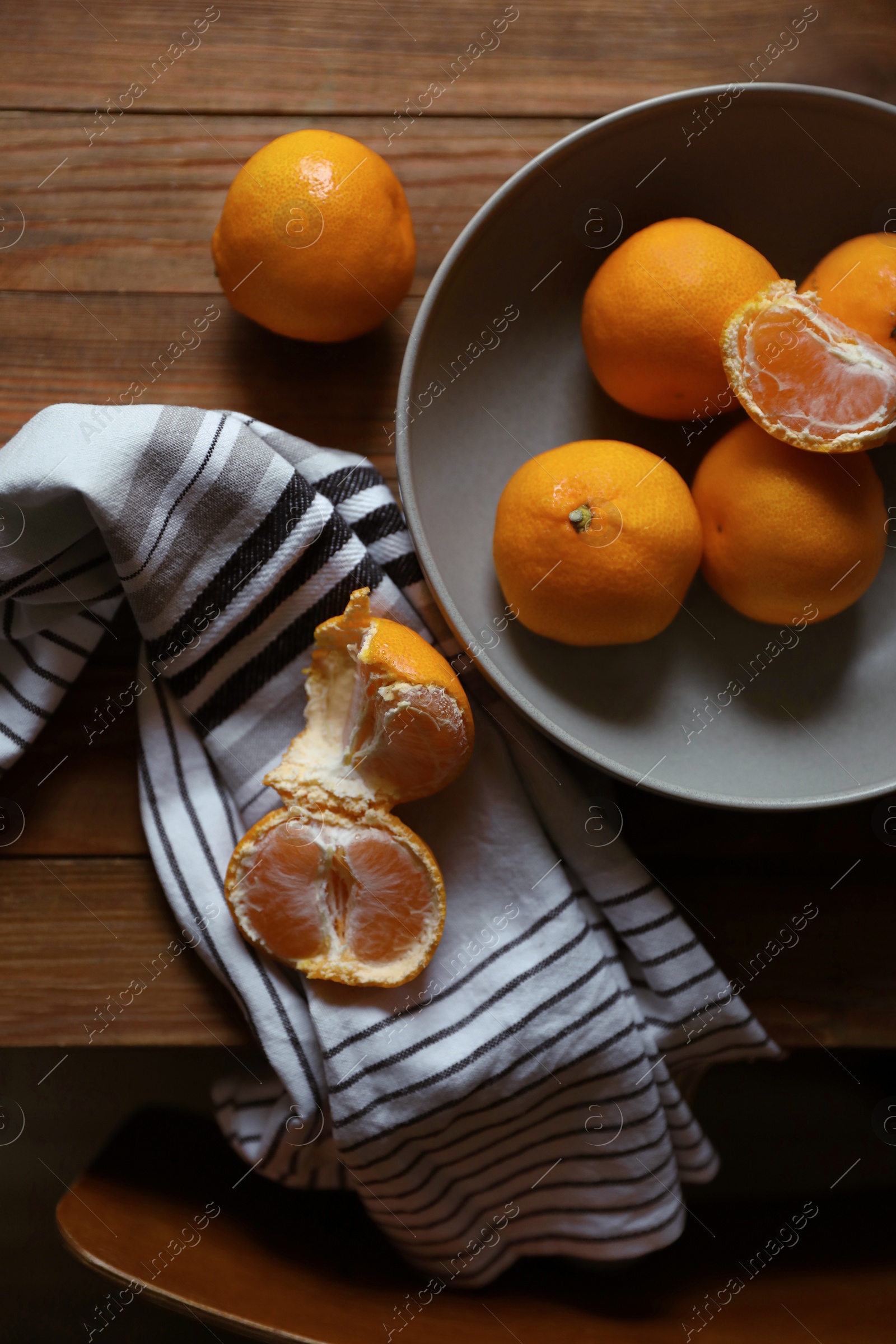 Photo of Fresh ripe tangerines on wooden table, flat lay