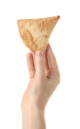 Woman holding fresh delicious crispy samosa on white background, closeup