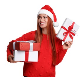 Young woman in red sweater and Santa hat with Christmas gifts on white background