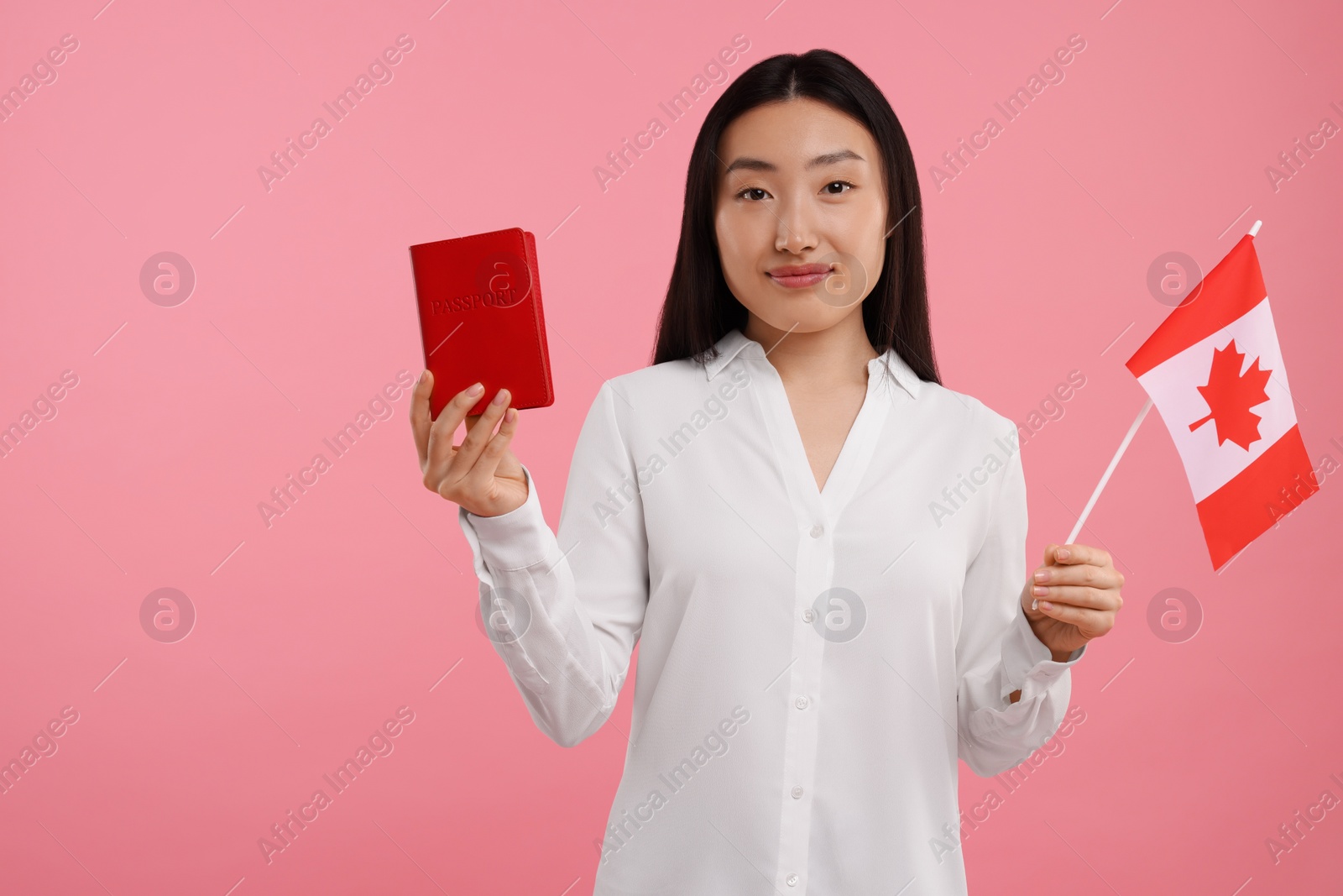 Photo of Immigration to Canada. Woman with passport and flag on pink background, space for text