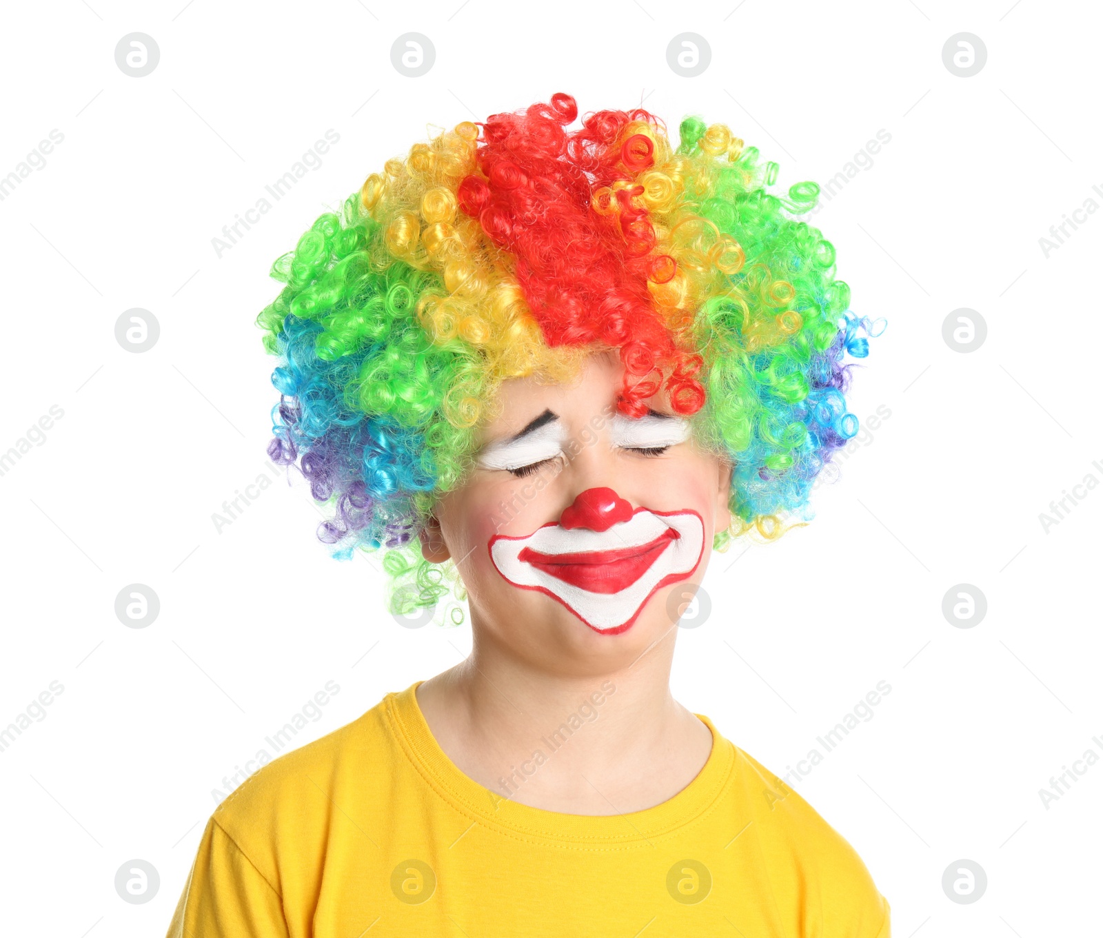 Photo of Preteen boy with clown makeup and wig on white background. April fool's day