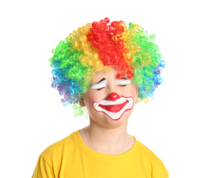 Photo of Preteen boy with clown makeup and wig on white background. April fool's day