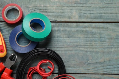 Photo of Flat lay composition with electrician's tools and accessories on blue wooden background, space for text